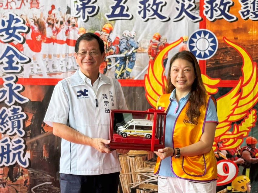 造福鄉民永續守護 顧蓓靜攜手獅子會贈新北消高頂救護車 2 《圖說》消防局長陳崇岳回贈救護車模型給予顧蓓靜。〈消防局提供〉