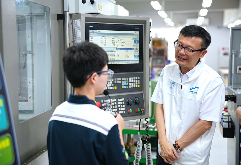 《圖說》模具科馬正念同學向張明文局長說明如何用五軸機多軸加工西洋棋騎士馬。〈教育局提供〉